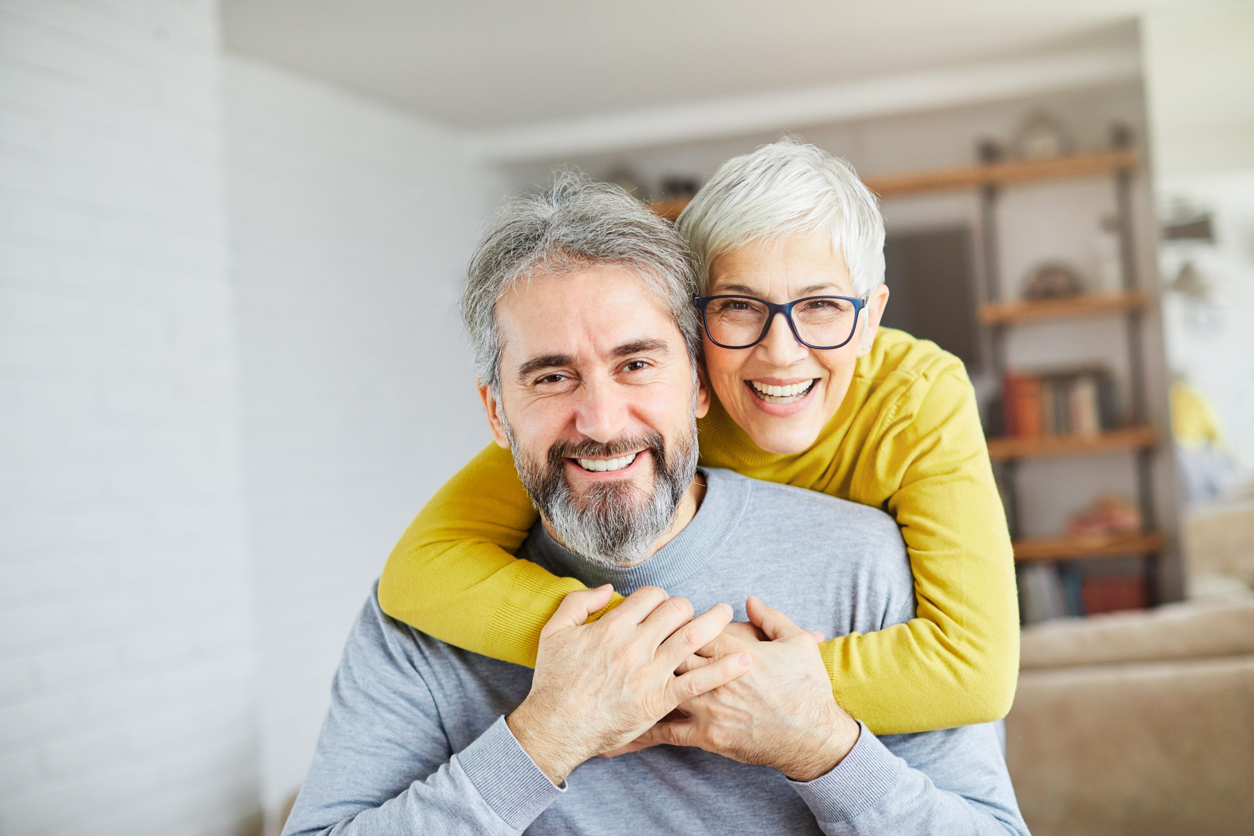 Older couple smiling, the kind of long-term dental care Avenue Dentistry provides in Morgan Hill